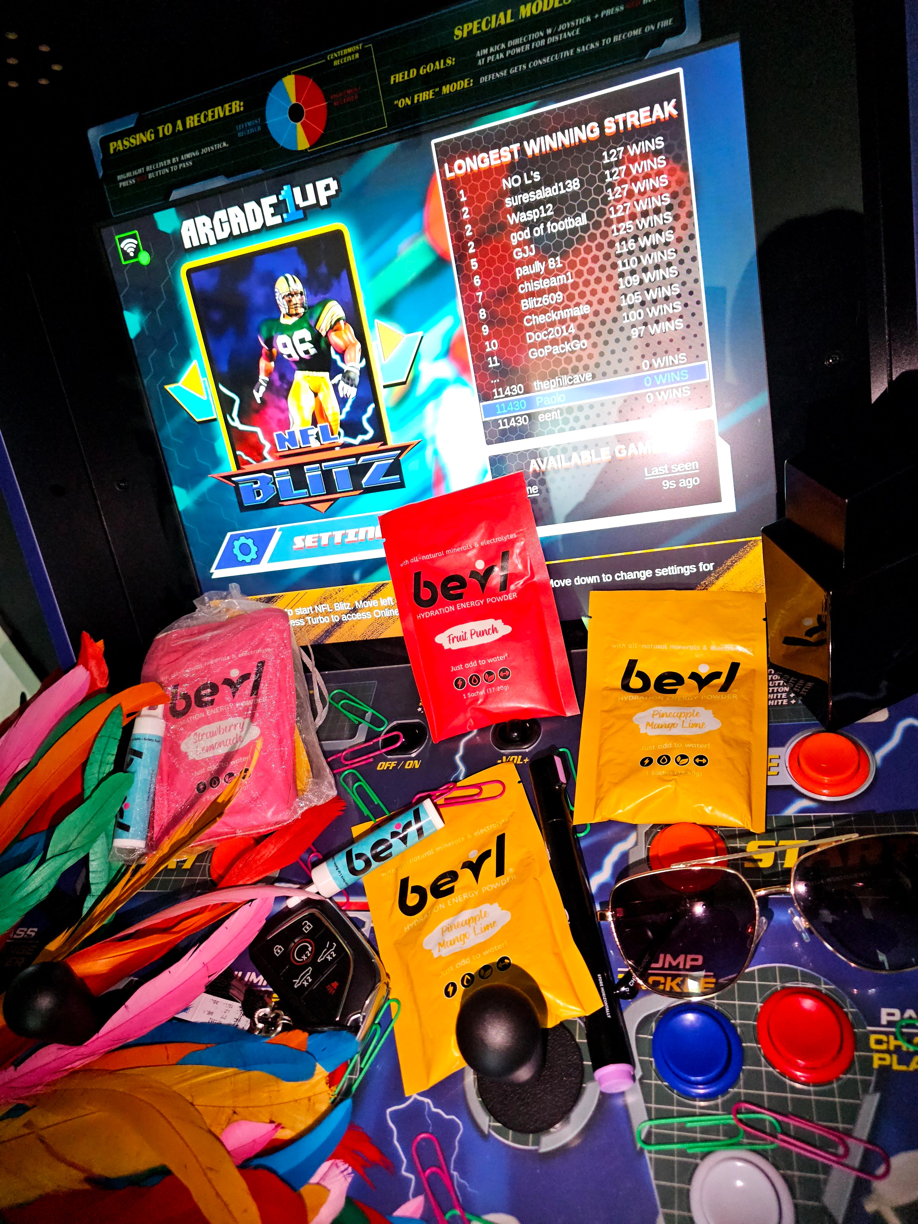 Colorful items including a laptop, bevl products, and stationery on a desk.